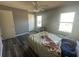 Bright bedroom with plank floors, a ceiling fan, and two windows at 3801 Battleview Ct, North Charleston, SC 29420