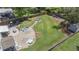 Aerial view of the backyard featuring a fire pit, patio, and lush green lawn at 4019 Cascades Thrust, Summerville, SC 29483