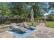Backyard featuring patio with lounge chairs, lush greenery, and a cozy fire pit area for relaxation and entertaining at 4019 Cascades Thrust, Summerville, SC 29483