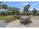 Beautiful backyard with patio, dining set, lush lawn, and mature trees, perfect for outdoor entertaining at 4019 Cascades Thrust, Summerville, SC 29483