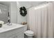 Stylish bathroom with a pristine white sink vanity, toilet, and tub-shower combo with a neutral shower curtain at 4019 Cascades Thrust, Summerville, SC 29483