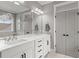 This spacious bathroom has double sinks with white cabinets and a large mirror at 4019 Cascades Thrust, Summerville, SC 29483