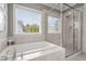 Elegant bathroom features a luxurious soaking tub next to a window and a glass-enclosed shower at 4019 Cascades Thrust, Summerville, SC 29483