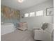 Bright Bedroom featuring a crib, dresser and charming jungle-themed wallpaper, creating a serene and playful space at 4019 Cascades Thrust, Summerville, SC 29483