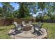 Inviting fire pit area with Adirondack chairs, surrounded by lush landscaping and a wood fence at 4019 Cascades Thrust, Summerville, SC 29483