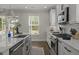 Bright kitchen featuring an island, stainless appliances and sink, and a large window with a view to the backyard at 4019 Cascades Thrust, Summerville, SC 29483