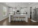 Kitchen featuring white cabinets, stainless steel appliances, hardwood floors, and a large central island with seating at 4019 Cascades Thrust, Summerville, SC 29483