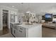 Kitchen with white marble countertops, stainless steel appliances and open floor plan leading to a living area at 4019 Cascades Thrust, Summerville, SC 29483