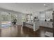 Bright, open kitchen with white cabinets, a large island with seating, and stainless steel appliances at 4019 Cascades Thrust, Summerville, SC 29483