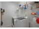Well-organized laundry room with white washer and dryer, wire shelving for storage, and neutral walls at 4019 Cascades Thrust, Summerville, SC 29483