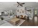Spacious open-concept living room, featuring a staircase, modern furnishings, and kitchen access at 4019 Cascades Thrust, Summerville, SC 29483