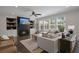 Bright living room features fireplace, built-ins, hardwood floors, large windows with backyard view at 4019 Cascades Thrust, Summerville, SC 29483