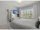 Relaxing main bedroom featuring a TV, large window and an adjacent bathroom providing a private and tranquil retreat at 4019 Cascades Thrust, Summerville, SC 29483
