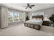 Sunlit primary bedroom features a large window, neutral walls, carpet, and ceiling fan at 4019 Cascades Thrust, Summerville, SC 29483