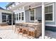 Stylish outdoor kitchen featuring a stone bar with seating, a built-in grill, and a pergola at 4019 Cascades Thrust, Summerville, SC 29483
