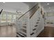 Elegant staircase with wooden handrail connects to the bright living area, showcasing seamless transition at 4019 Cascades Thrust, Summerville, SC 29483
