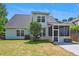 Exterior view of house and screened in porch with a well-maintained backyard at 402 Bay Creek Dr, Charleston, SC 29414