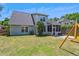 Home's backyard with lush green grass, a playground set, and a charming exterior at 402 Bay Creek Dr, Charleston, SC 29414