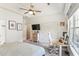 Large primary bedroom features a tray ceiling, ceiling fan, carpeted floors, a work space and closet at 402 Bay Creek Dr, Charleston, SC 29414