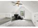 Cozy attic bedroom with sloped ceilings, comfortable workspace, and carpeted floor at 402 Bay Creek Dr, Charleston, SC 29414
