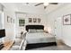 Bedroom features a tray ceiling, ceiling fan, carpeted floors, and a work space with backyard views at 402 Bay Creek Dr, Charleston, SC 29414