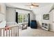 Bedroom featuring a crib, comfortable armchair, and a bookshelf for storage at 402 Bay Creek Dr, Charleston, SC 29414