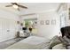 Bright bedroom features a tray ceiling, ceiling fan, carpeted floors, a work space and backyard view at 402 Bay Creek Dr, Charleston, SC 29414