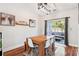 Cozy dining space featuring a wooden table with white chairs and a sliding glass door leading to the backyard at 402 Bay Creek Dr, Charleston, SC 29414