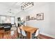 Bright dining area with a wooden table, white chairs, and views into the living room with a fireplace at 402 Bay Creek Dr, Charleston, SC 29414