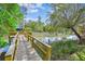 Wooden dock overlooking a marsh with trees, vegetation, and blue skies above at 402 Bay Creek Dr, Charleston, SC 29414