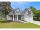 Charming two-story home featuring a well-manicured lawn, attached two car garage, and welcoming front porch at 402 Bay Creek Dr, Charleston, SC 29414