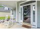 Inviting front porch with rocking chairs, columns, and decorative details at the home's entrance at 402 Bay Creek Dr, Charleston, SC 29414