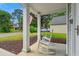 Inviting front porch with rocking chairs and view of the street at 402 Bay Creek Dr, Charleston, SC 29414