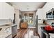 Bright eat-in kitchen features stainless appliances, granite countertops, white cabinetry, and a backyard view at 402 Bay Creek Dr, Charleston, SC 29414