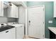 A laundry room with a washer, dryer, cabinets, and exterior access at 402 Bay Creek Dr, Charleston, SC 29414