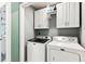 This laundry room features a washer, dryer, and storage cabinets for convenience at 402 Bay Creek Dr, Charleston, SC 29414