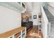 Open-concept living room with a cozy couch, wood floors, and staircase to the second floor at 402 Bay Creek Dr, Charleston, SC 29414