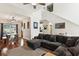 Open-concept living room with a gray sectional, wood floors, and natural light, connected to the dining area at 402 Bay Creek Dr, Charleston, SC 29414