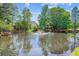 Backyard pond featuring a fountain surrounded by lush greenery and trees at 402 Bay Creek Dr, Charleston, SC 29414