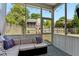 Inviting screened porch featuring a comfortable sofa and backyard views with playhouse and swing set at 402 Bay Creek Dr, Charleston, SC 29414