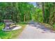 Picturesque trail view featuring a bench along a paved path surrounded by lush greenery and trees at 402 Bay Creek Dr, Charleston, SC 29414