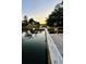 Calm water view reflecting the trees and houses at dusk with a wooden structure visible on the water at 402 Bay Creek Dr, Charleston, SC 29414