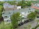 Aerial view of a multi-story home highlighting its rooftop, porches, and surrounding lush trees at 41 Legare St # C, Charleston, SC 29401