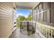 Balcony with spiral staircase and a view of lush greenery and blue sky at 41 Legare St # C, Charleston, SC 29401