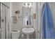 Bright bathroom featuring a pedestal sink, towel racks, and walk-in shower at 41 Legare St # C, Charleston, SC 29401