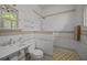 Bathroom featuring a combination shower and tub with a pedestal sink at 41 Legare St # C, Charleston, SC 29401