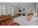 Bedroom featuring a decorative fireplace, hardwood floors, and sunny windows at 41 Legare St # C, Charleston, SC 29401