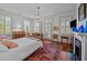 Bedroom with decorative fireplace, natural light, and red oriental rug at 41 Legare St # C, Charleston, SC 29401