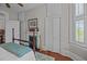 Cozy bedroom with a fireplace, antique bed frame, and traditional furnishings at 41 Legare St # C, Charleston, SC 29401