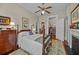 Bedroom boasts an open door to a bookshelf lined bonus room and decorative fireplace at 41 Legare St # C, Charleston, SC 29401